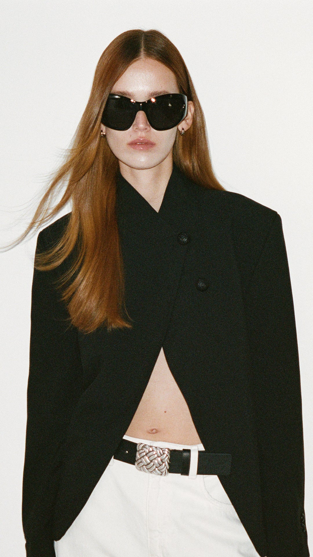 MODEL WEARING A BLACK BELT WITH A SILVER BUCKLE