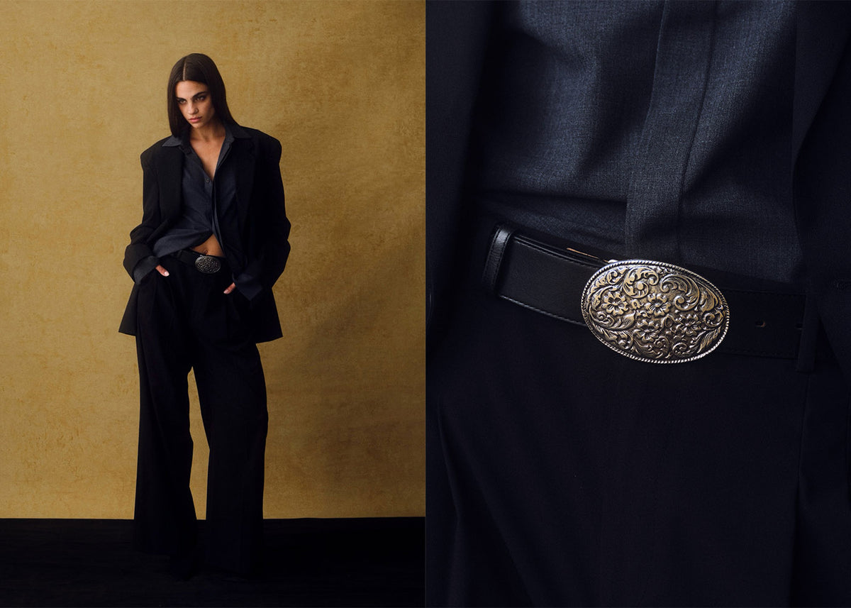 model wearing dark suit with a silver western plaque belt