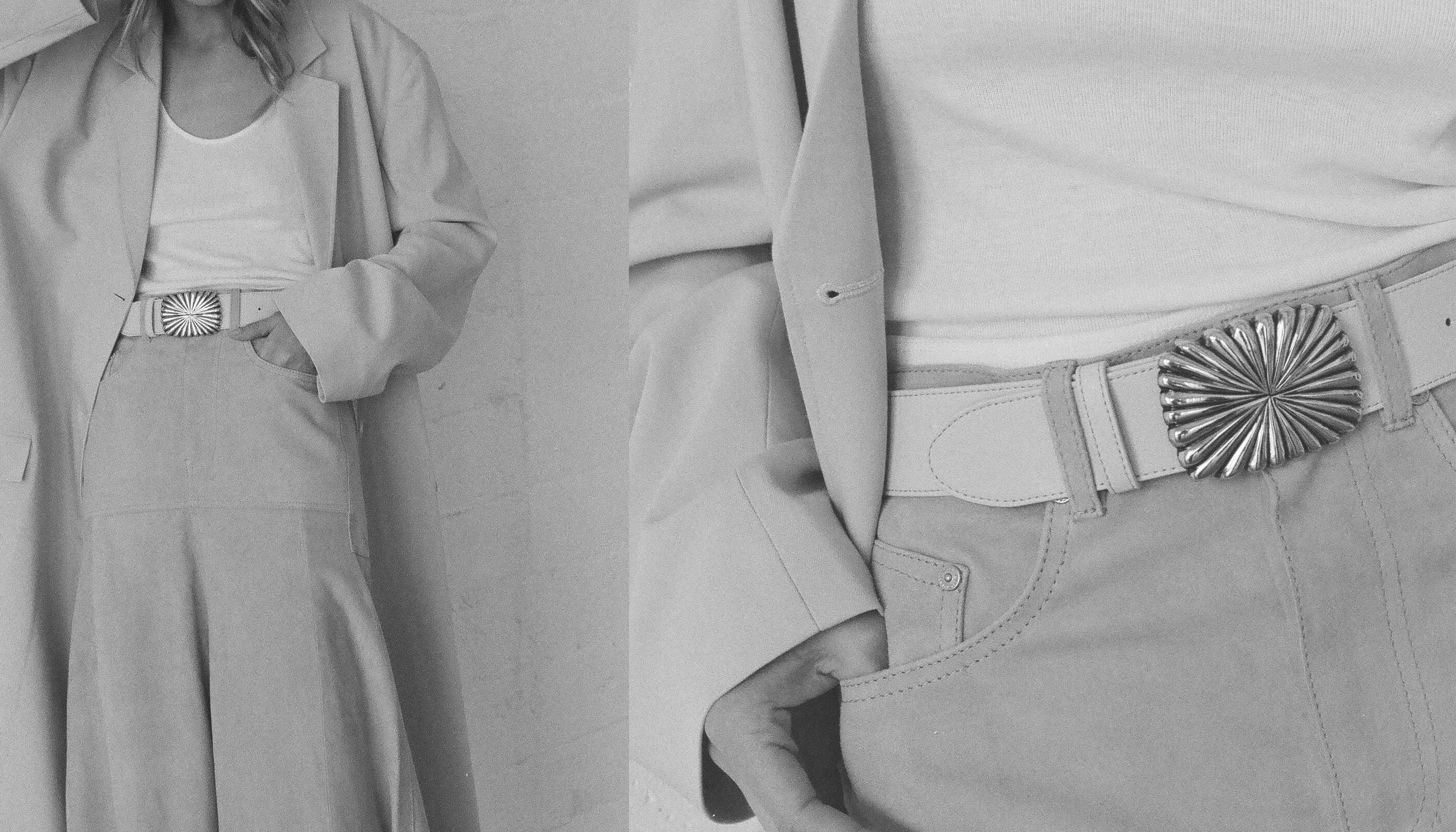 Gray suit with a belt featuring a decorative buckle on a plain background