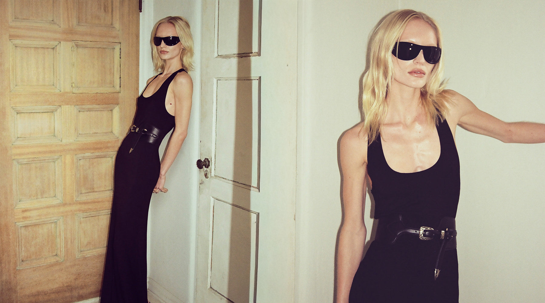 Woman in a black dress and sunglasses standing in front of a wooden door.