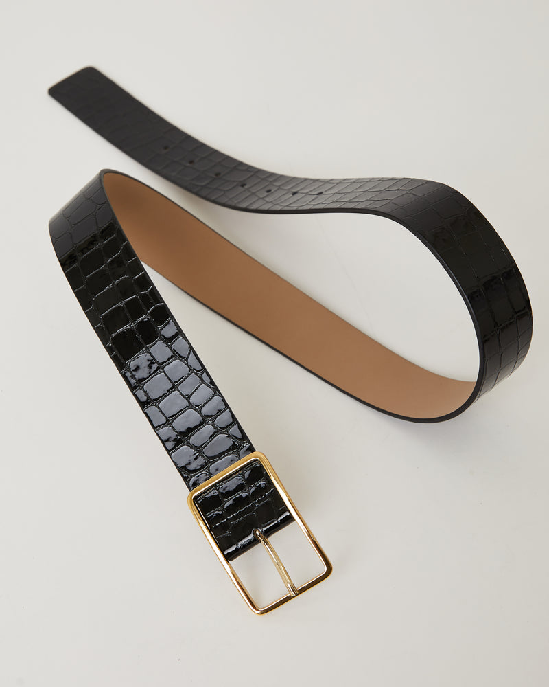 Black shiny leather belt with croc-embossed finish. Fastens with simple gold triangle shaped buckle.