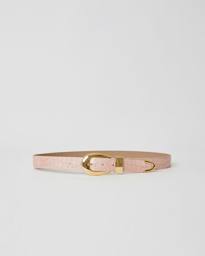 Light pink shiny leather belt with croc-embossed strap. Detailed with shiny gold rounded buckle, keeper, and tip accent.